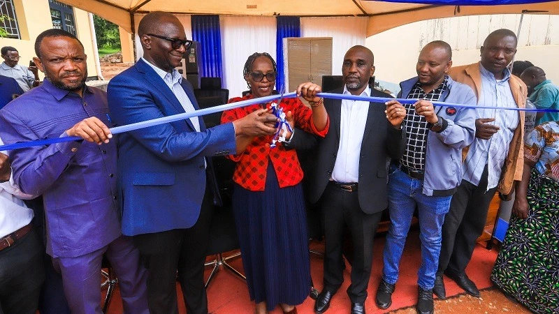 Hadija Kabojela, (Centre) Ushetu District Executive Director cutting a ribbon to signify the official handover of a refurbished Bulungwa Health HIV Care and Treatment Clinic with medical equipments worth 768m/- by Tanzania Health Promotion Support