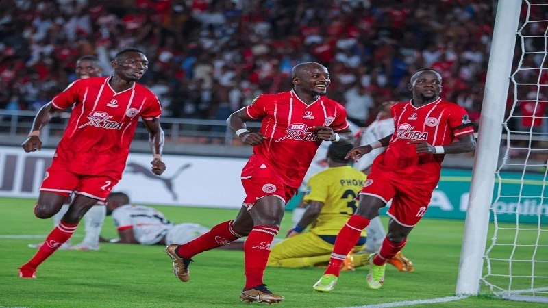 Simba SC's players (L-R) attacker Pa Omar Jobe, winger Saidi Ntibazonkiza, and midfielder Clatous Chama jubilate when Ntibazonkiza netted for the squad in a 2023/24 CAF Champions League 