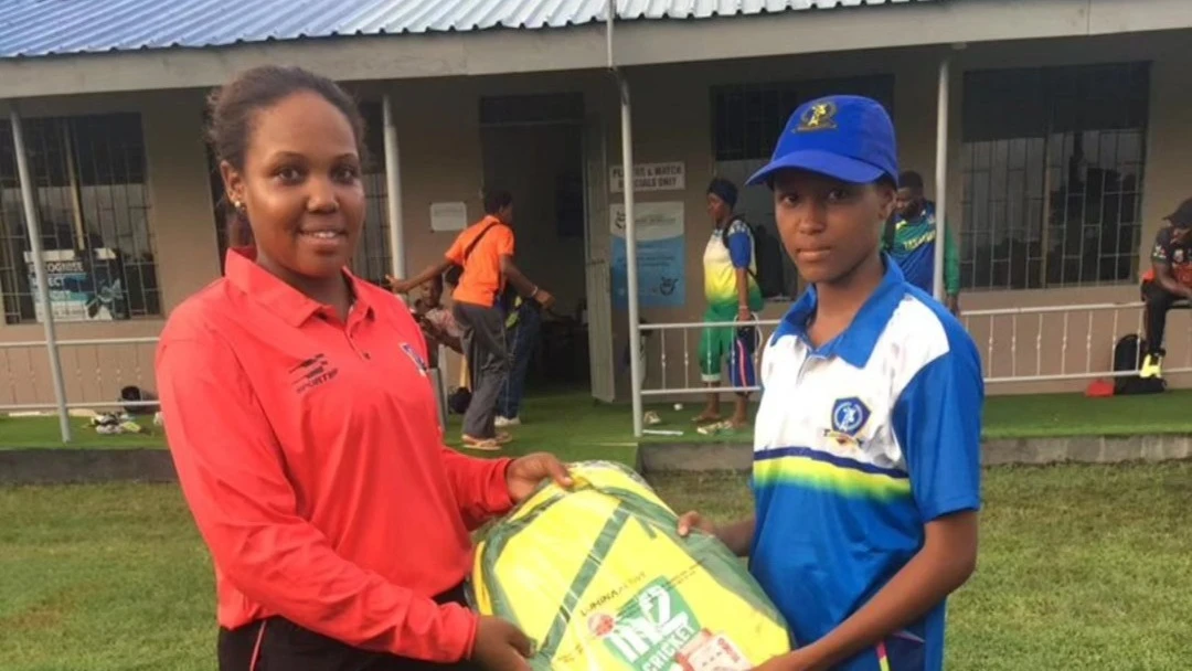 Ngorongoro Girls' Maria Justine (R) receives Player of the Match prize from umpire Nasra Hamza after excelling in the 2024 Tanzania Cricket Association (TCA) U-17 Women's Easter Series' clash against Serengeti Girls which took place in Dar es Salaam 