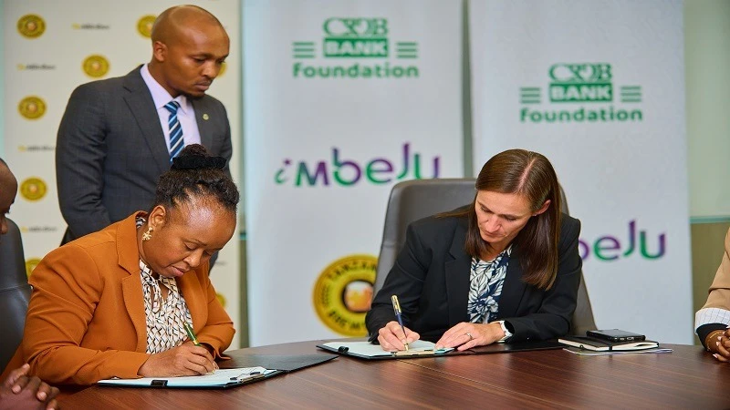 Michelle Kilpin (R), TBL Managing Director, signs a MoU with Tully Mwambapa of CRDB Foundation, for barley farming pre-financing.
