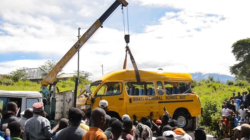 Residents of Sinoni ward in Arusha view the wreckage of the Ghati Memorial School mini-bus which plunged into Mbasi River yesterday morning, leaving eight students dead and three injured.