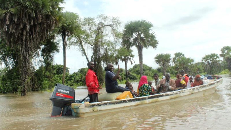 Some of the Kibiti district leaders in Coast region, using a boat to rescue some residents of Maparoni ward villages which were hit by floods in the district yesterday.