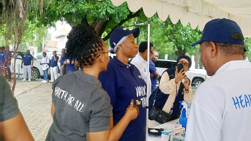 Minister for Health Ummy Mwalimu (C) being measured height after participating in a five kilometer walk organised by the World Health Organization (WHO) in Dar es Salaam at the weekend as a continuation of the World Health Day.