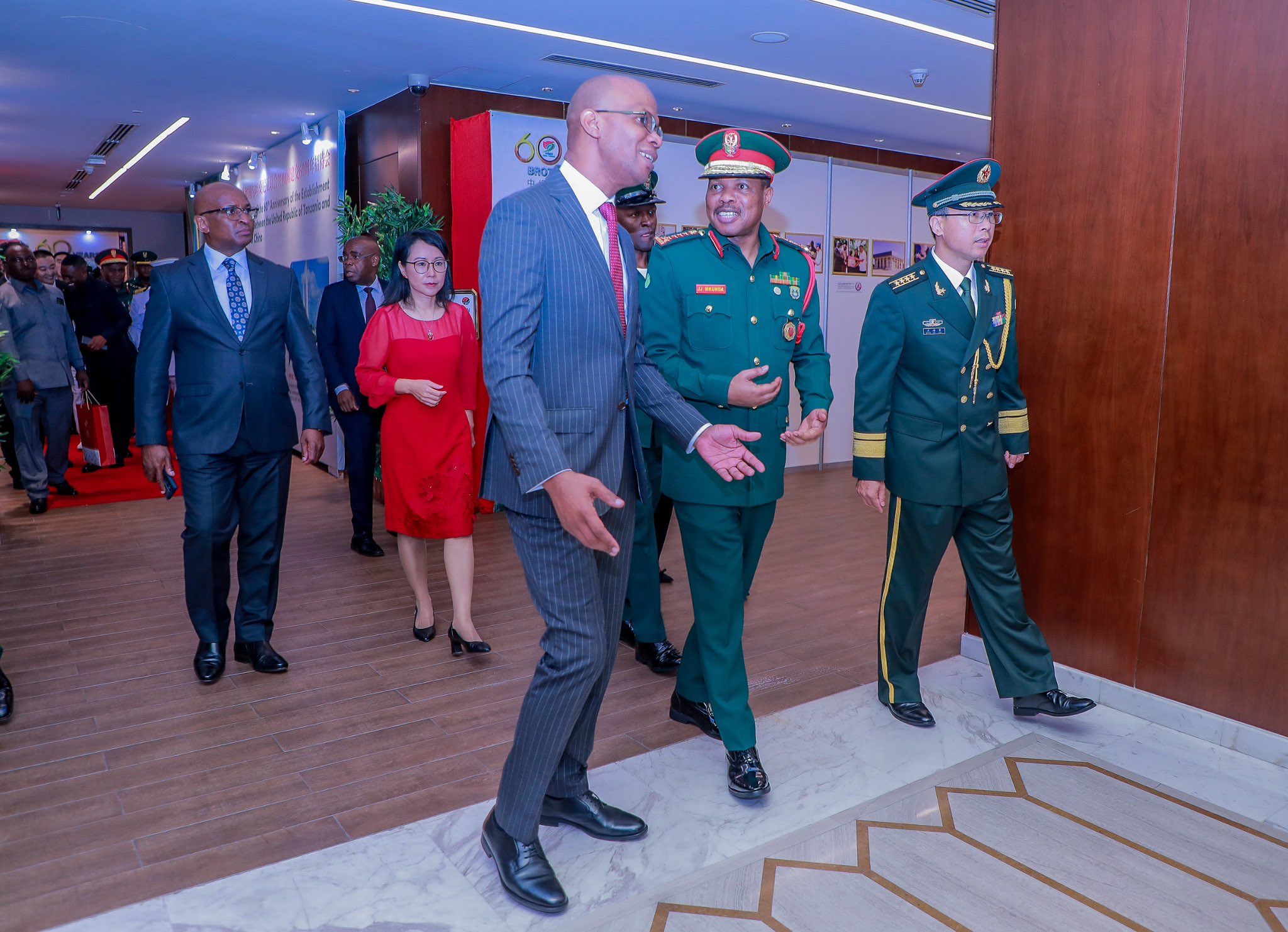 Minister January Makamba (L) and CDF Jacob Mkunda (C) head to the hall for the 60th anniversary celebration of Tanzania-China diplomatic relations in Dar es Salaam. Chinese Ambassador Chen Mingjian is pictured in the background (R). 
