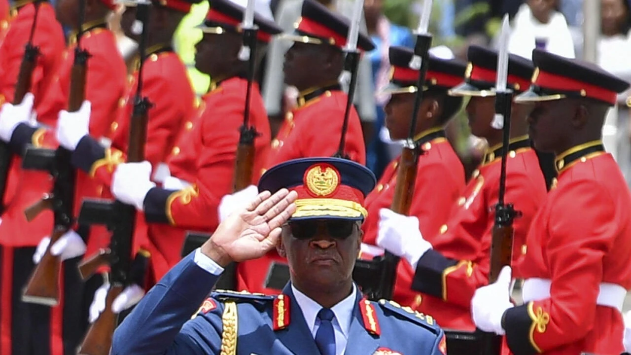 Kenya's defence chief General Francis Omondi Ogolla (C) gestures as Britain's King Charles III (unseen) and Kenyan President William Ruto (unseen) arrive at the tomb of the Unknown Warrior during a wreath-laying ceremony at Uhuru Gardens in Nairobi on Oct