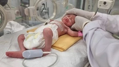 A Palestinian baby girl, saved from the womb of her mother Sabreen Al-Sheikh (Al-Sakani), who was killed in an Israeli strike along with her husband Shokri and her daughter Malak, lies in an incubator at Al-Emirati hospital in Rafah in the southern Gaza 