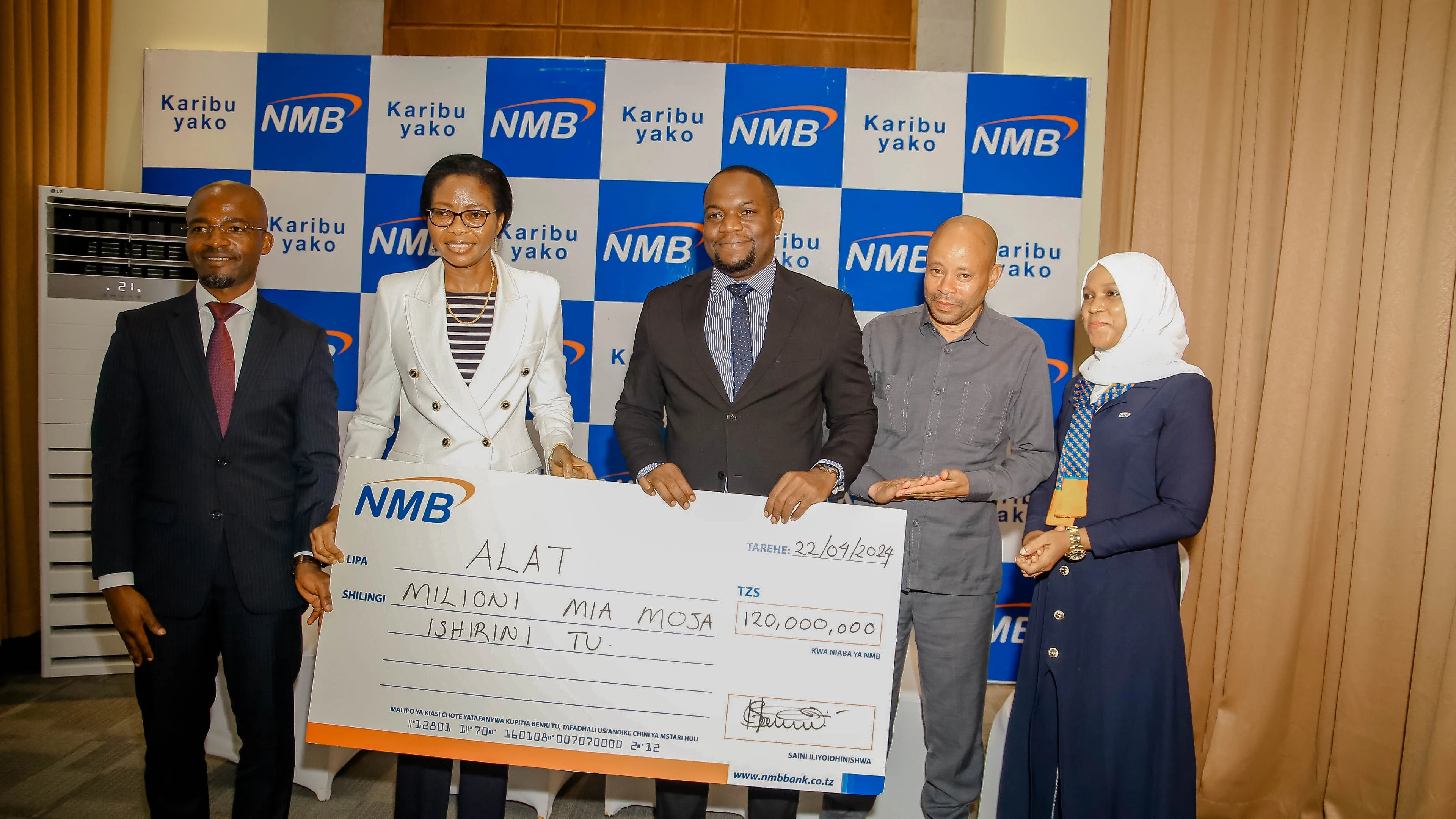 Ruth Zaipuna, bank chief executive officer (CEO) 2nd L), handsover dummy cheque worth 120ml/- to ALAT acting chairman Sima Constantine Sima (Ci) for the congress sponsorship yesterday in Zanzibar. Looking on are bank's Chief of Wholesale Banking Alfred.