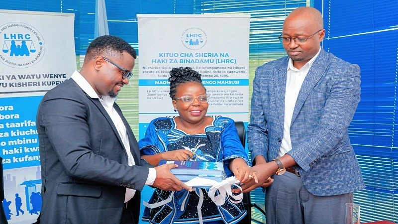 Legal and Human Rights Centre (LHRC) executive director Dr Anna Henga cuts a ribbon to launch the Tanzania Human Rights Report 2023 in Dar es Salaam yesterday.