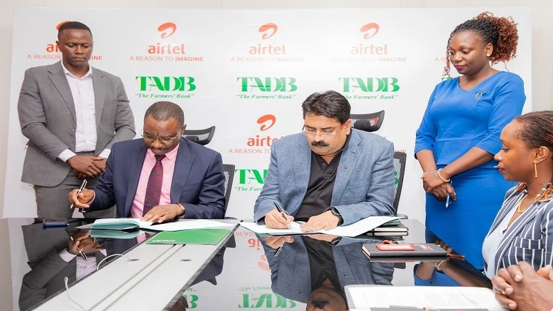 Airtel Tanzania's Director General Dinesh Balsingh and TADB Managing Director Frank Nyabundege sign MoU to boost agriculture. 