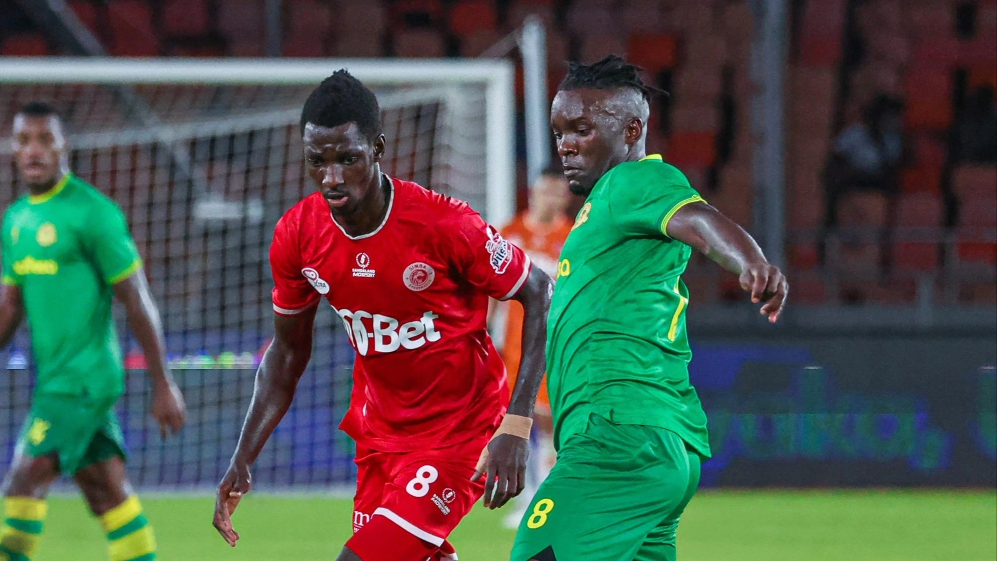 Yanga's defensive midfielder, Khalid Aucho (R), challenges Simba SC's midfielder Sadio Kanouté (C) as the former's teammate Joseph Guédé looks on when the squads locked horns in a 2023/24 NBC Premier League match which took place in Dar es Salaam 