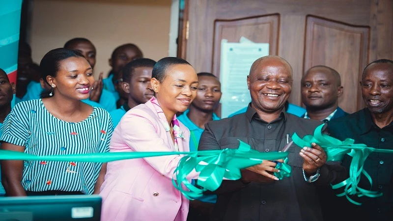 Cikay Richards (2nd L) CEO of Lyra in Africa and Mathias Mvula, cut a ribbon to inaugurate the new computer lab at Morogoro Teachers College