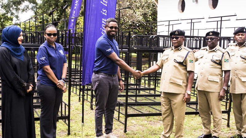 Stanley Kafu (3rd-L), Exim Bank Tanzania’s head of marketing, presents beds to SACP Ramadhani Mungi, Commandant of the Tanzania Police School in Moshi municipality on Wednesday.