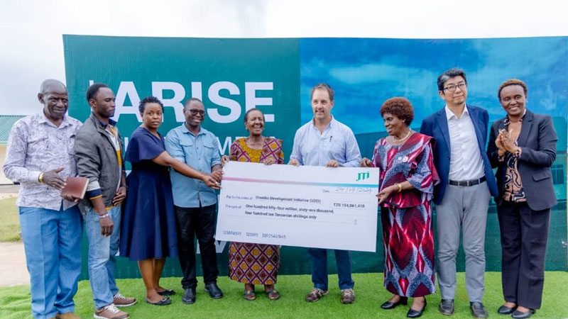 JTI Leaf Services Board chairperson Anne Makinda (3rd-R) pictured late last week presenting a dummy cheque to Urambo Development Initiative chairperson Margaret Sitta.