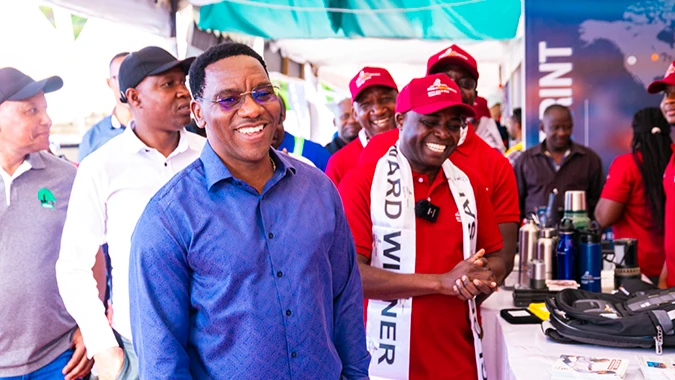 Arusha Regional Commissioner, Mr Paul Makonda (left) and Dr Kiva Mvungi, Senior Manager - Health, Safety and Environment at GGML (right) share a light moment at the GGML booth during the 2024 OSHA exhibition at the General Tyres Showgrounds in Arusha. 