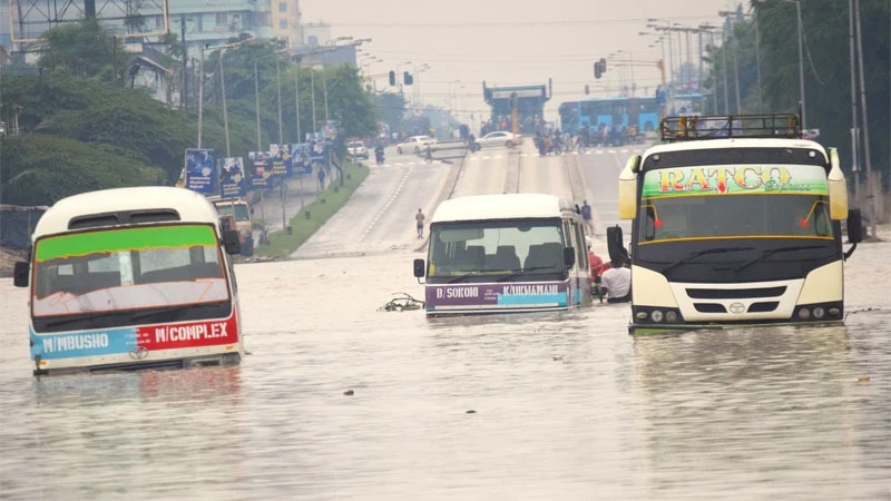 Dar es Salaam commuter buses strapped in the water floods at Jangwani area along Morogoro road following the ongoing rain yesterday.
Photo: Ibrahim Juma
Dar es Salaam commuter buses strapped in the water floods at Jangwani area along Morogoro road .