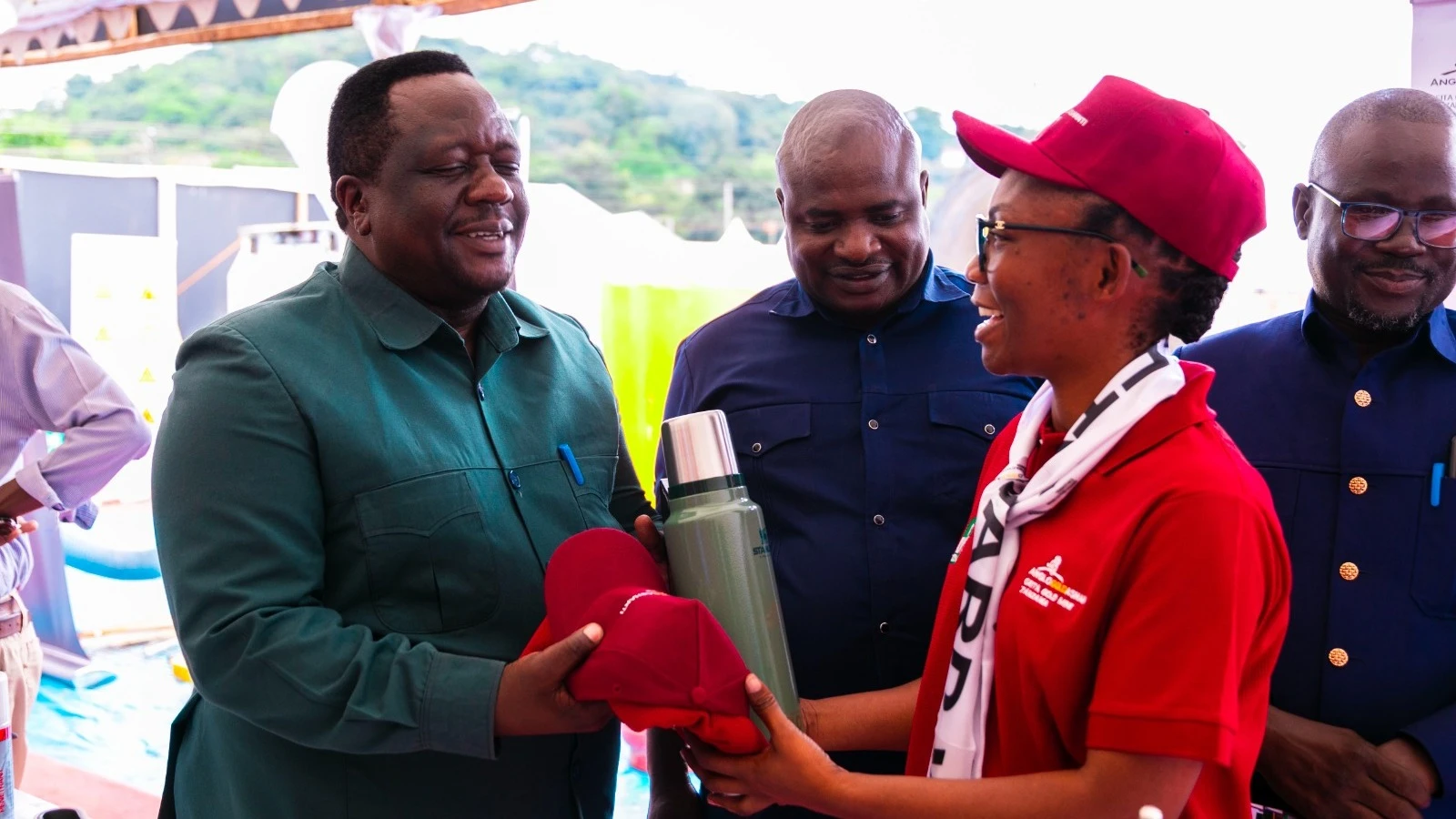 The President of the Tanzania Confederation of Trade Unions (TUCTA), Tumaini Nyamhoka, receives a gift from GGML’s Senior Officer - Social and Economic Development, Ruth Mharagi, during a visit to the GGML stand at the OSHA exhibition in Arusha.