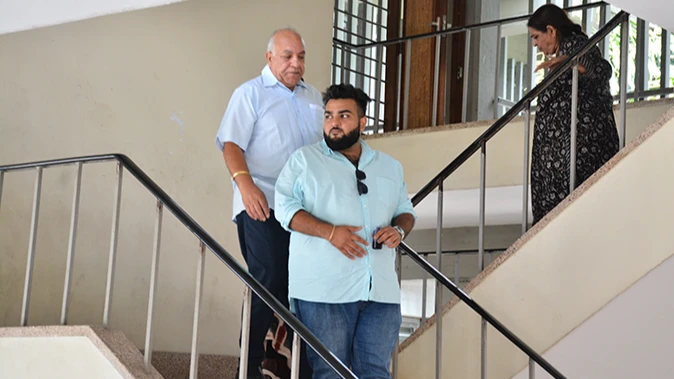Bharat Nathwani (in the middle) and his wife Sangita Bharat coming down the stairs at the Kisutu Resident Magistrate's Court in Dar es Salaam yesterday to hear their case of injuring their neighbor.