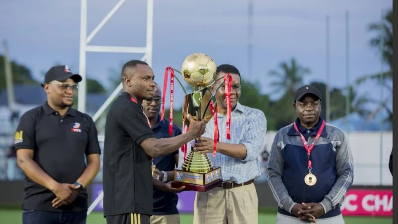 
Chairman of the Tanzanian Premier League Board (TPLB) Steven Mnguto (2nd R) presents the First Division League (NBC Championship) trophy to Kengold captain Charles Masai in Dar es Salaam yesterday.