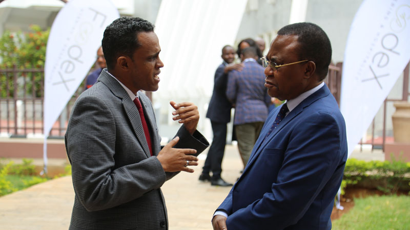 Agriculture minister Hussein Bashe (L) exchanges views with Isimani MP William Lukuvi outside the debating chamber of the National Assembly yesterday. 