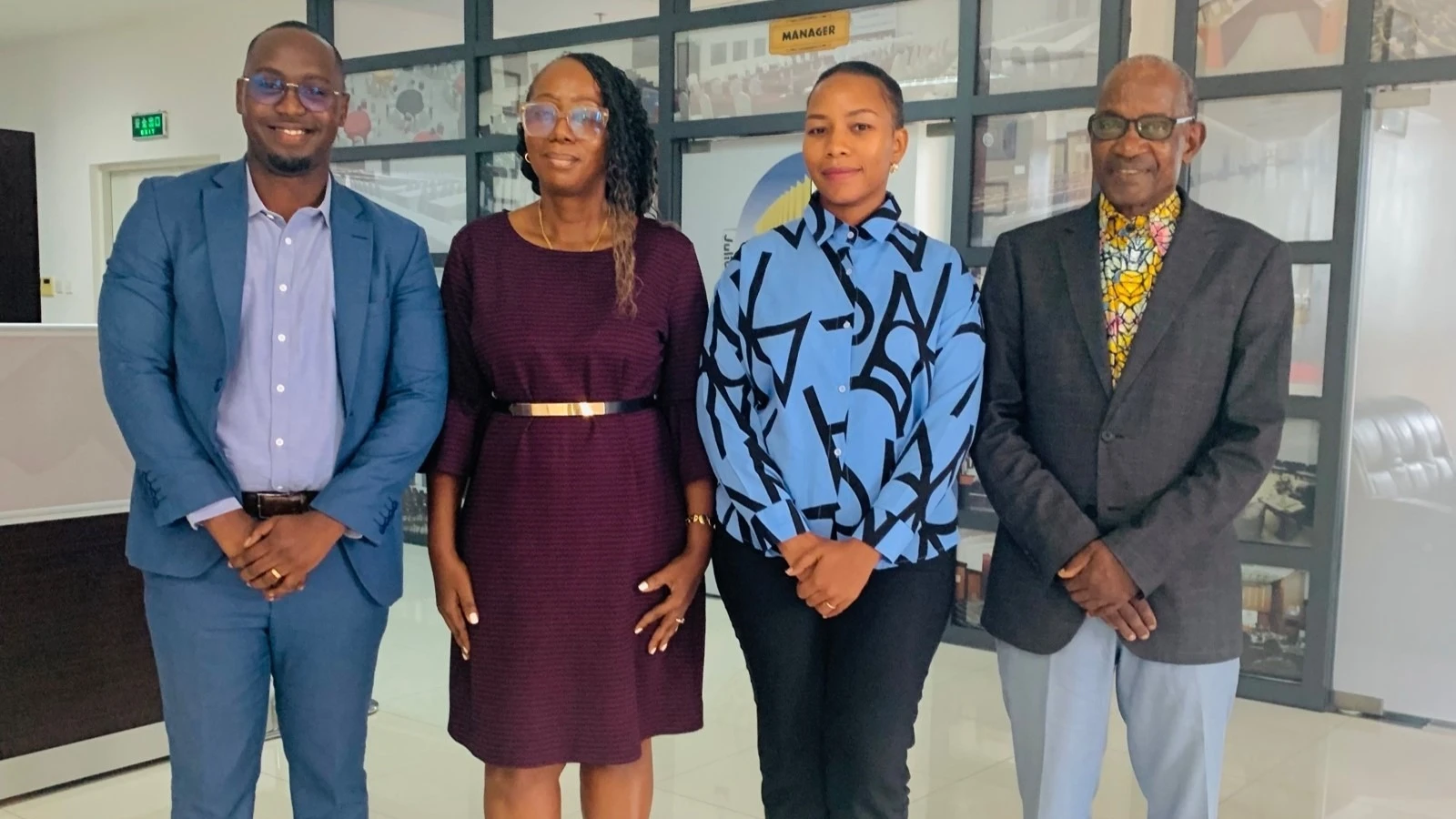 Arusha International Conference Centre (AICC) Managing Director, Christine Mwakatobe (2nd L), poses in a picture with Tanzania Honey Junction Managing Director Rose Msangi (2nd R) and other officials after a brief meeting held in Arusha. 