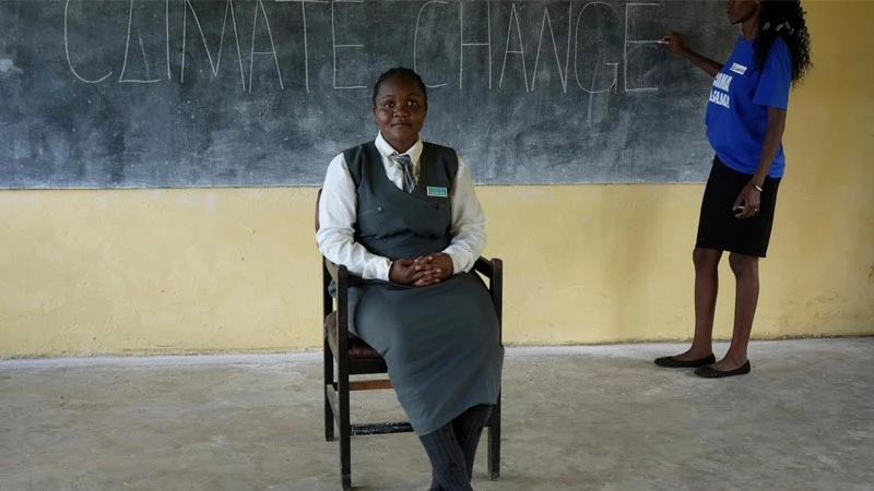 Bridget Chanda  left, interprets climate change terms to students, who are deaf, during a lesson at the Chileshe Chepela Special School in Kasama, Zambia

