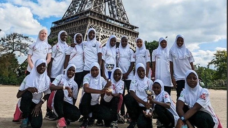 Zanzibar Sharks players in a group picture at the Eiffel Tower during their eight-day tour in France where they competed in this year’s edition of the Mondial Pupilles Plomelin Youth Tournament. 