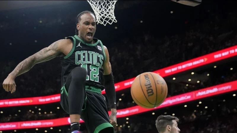 Boston Celtics forward Oshae Brissett (12) celebrates after dunking against the Indiana Pacers during the second half of Game 2 of the NBA Eastern Conference basketball finals on Thursday, May 23, 2024 in Boston.