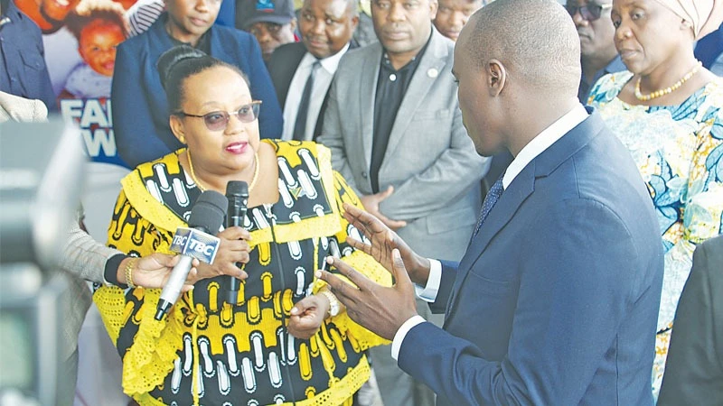 Constitution and Legal Affairs minister Dr Pindi Chana (L, in specs) has a word with Deputy Prime Minister and Energy minister Dr Doto Biteko at the launch of The Mama Samia Legal Aid Service Campaign in Njombe Region yesterday. 