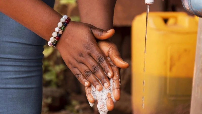 A patient handwashing  to prevent cholera outbreak