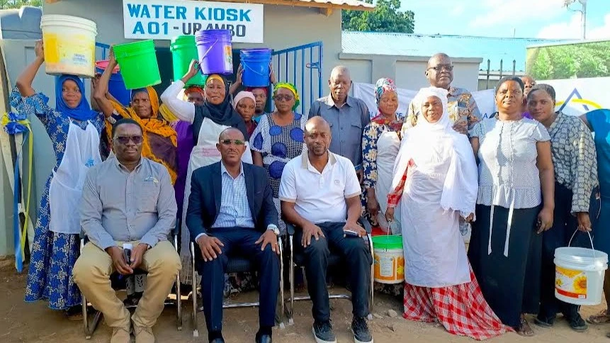 
The Urambo district Commissioner Elibariki Bajuta(C-seated) poses in a group photo with villagers benefitting from the newly donated water kiosk.