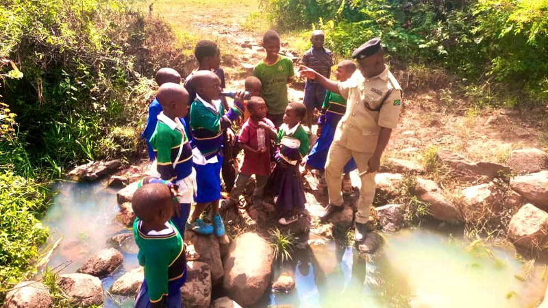 Assistant Inspector of Police John Namayala, currently stationed in Mbozi District’s Igamba ward, pictured on Thursday ‘lecturing’ Zelezeta Primary School pupils on the dangers of playing in stagnant water. 