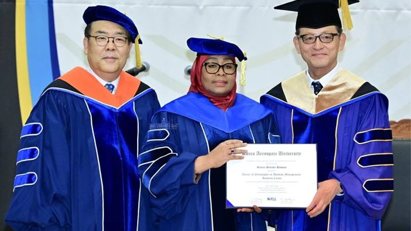 Hee Young Hurr, (R) President of Korean Aerospace University presenting President Samia Suluhu Hassan, with a Honorary Doctorate certificate in in the aviation sector.